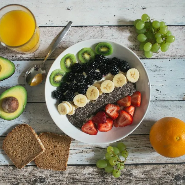 A breakfast bowl of banana, berries, kiwi, strawberries and chia seeds